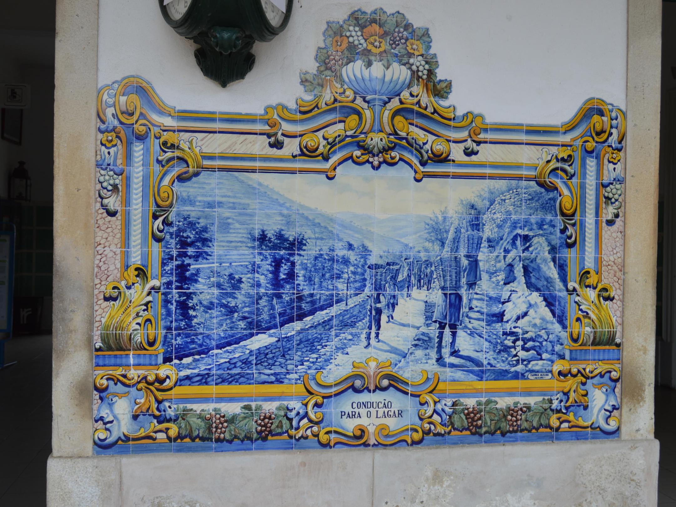 A decorative blue and white tile from the Pinhão train station, featuring beautiful designs that reflect local artistry.