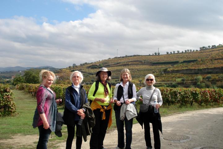 A group of five women enjoys a hike with a stunning vineyard backdrop in the Douro region.