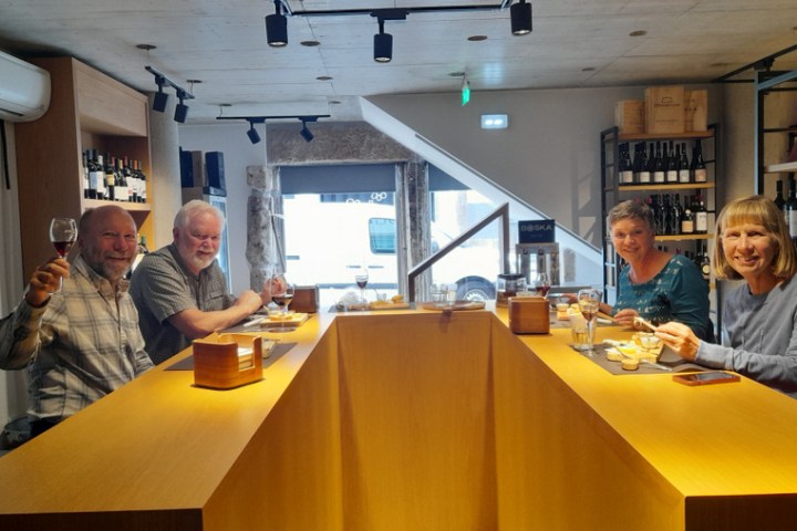 a group of people eating cheese during braga food tour