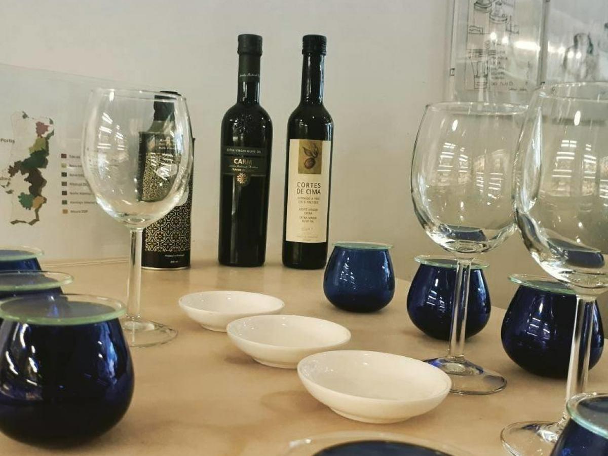 Setting the table for an olive oil tasting with wine and bread in Porto, featuring a rustic tablecloth and elegant glassware.