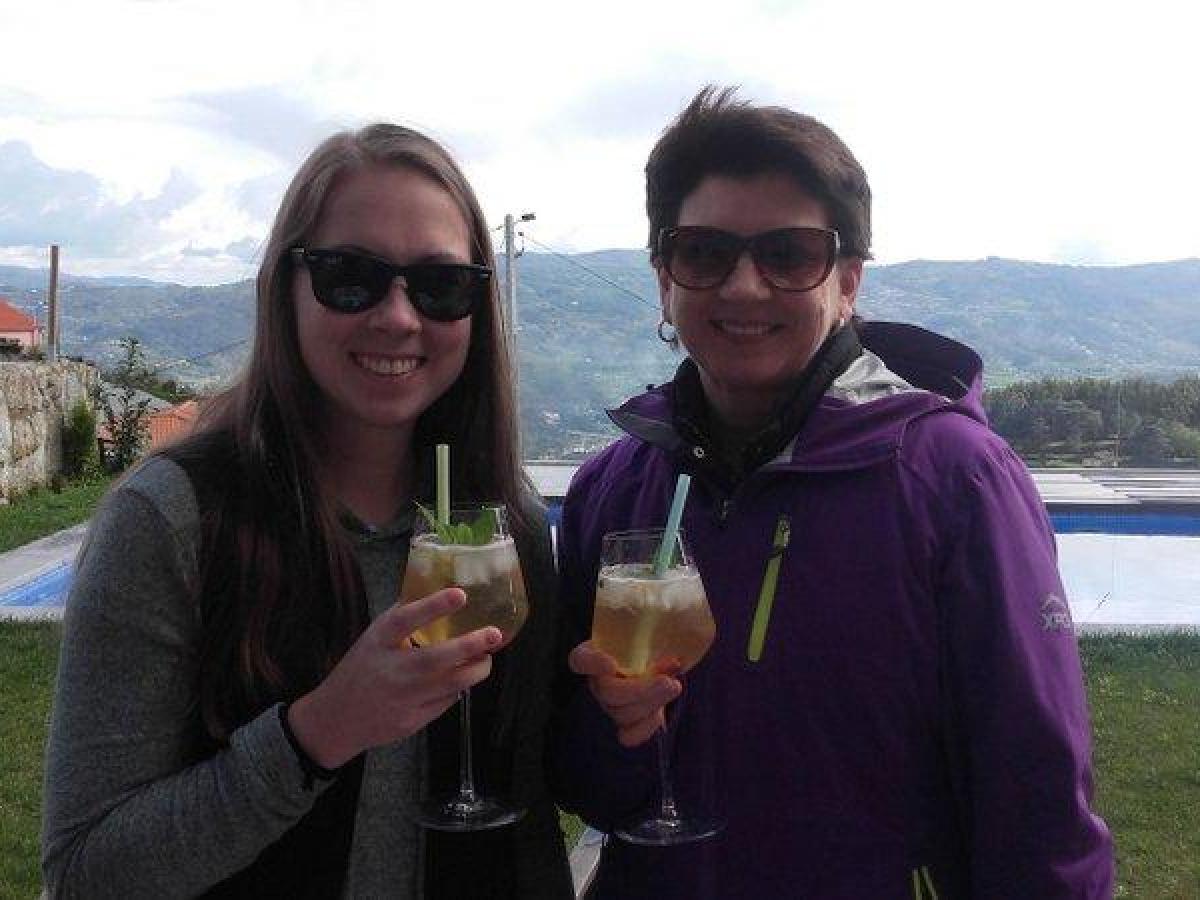 Two women drinking the Portuguese sangria, capturing a moment of joy and friendship.