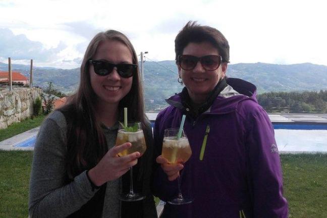 Two women drinking the Portuguese sangria, capturing a moment of joy and friendship.
