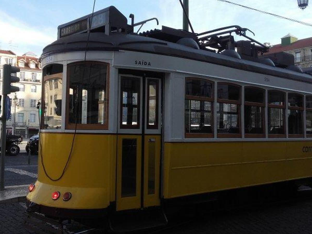 A cheerful yellow travels along Lisbon's scenic routes, embodying the city's iconic tram culture.