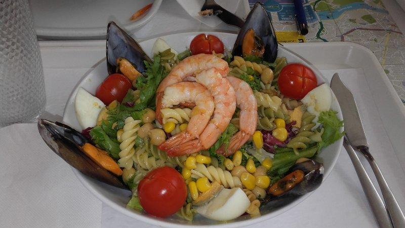 A vibrant plate featuring succulent shrimp salad, and fresh vegetables, perfect for a Portuguese food tour experience.