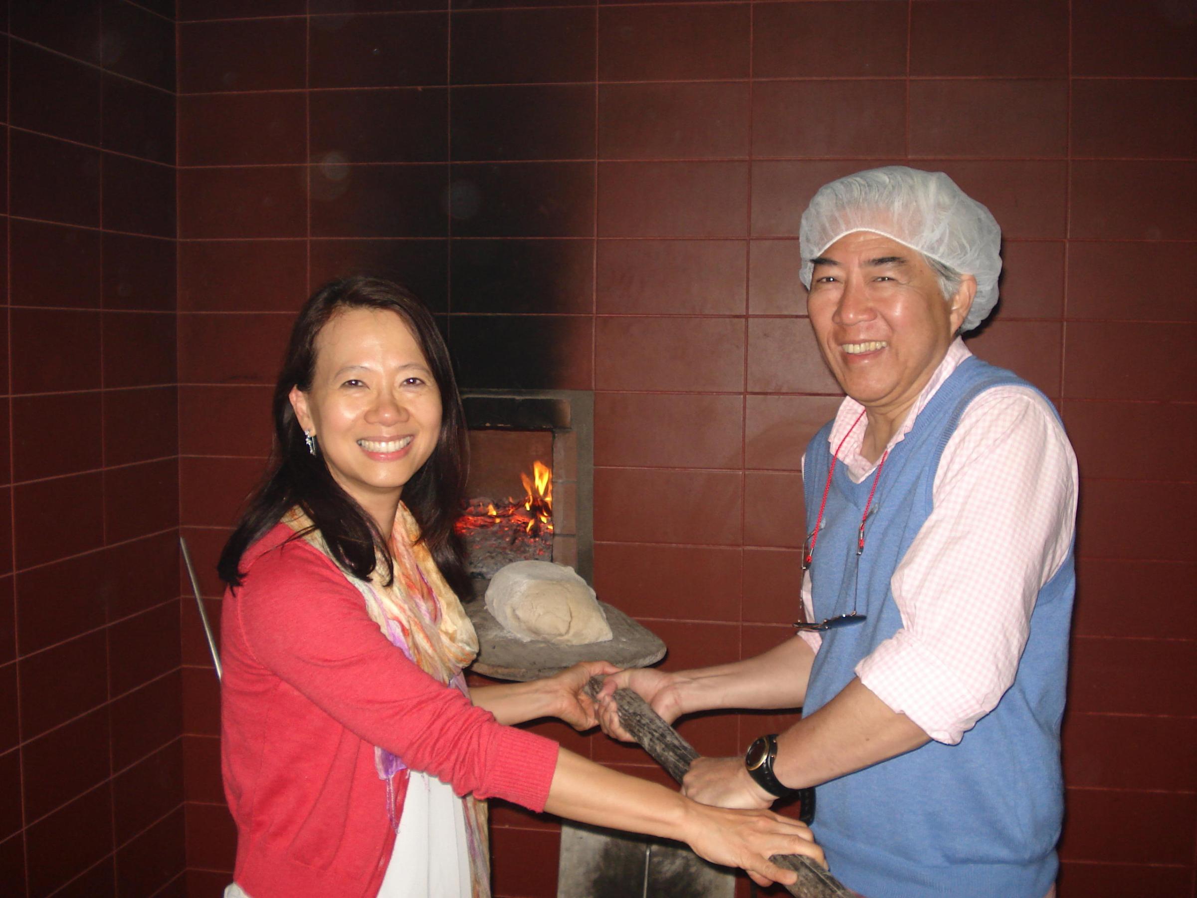 A man wearing a white hat enjoys a hands-on cooking class in Portugal.
