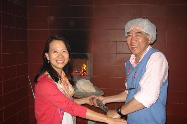 A man wearing a white hat enjoys a hands-on cooking class in Portugal.