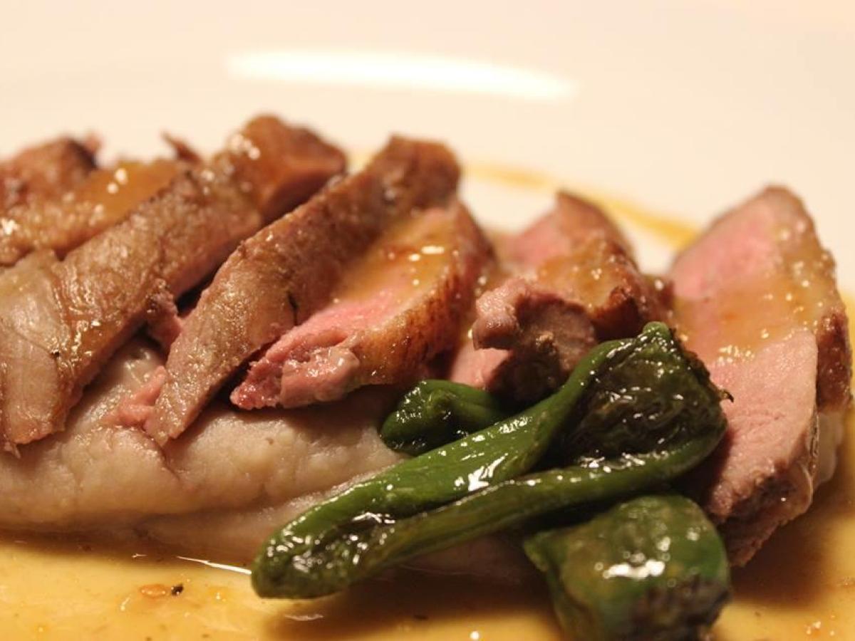 A delicious beef dish on a plate, topped with savory sauce, highlighting the flavors of Portugal's food tours.