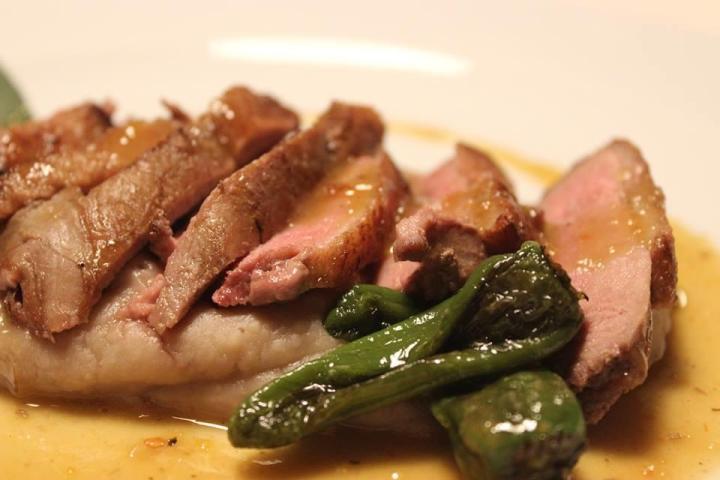 A delicious beef dish on a plate, topped with savory sauce, highlighting the flavors of Portugal's food tours.