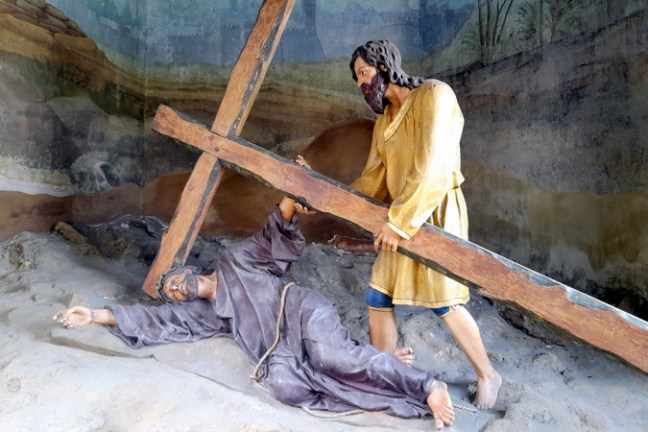 A statue of Jesus on the cross, symbolizing sacrifice, with a backdrop of the Braga tour highlighting Simon's support.