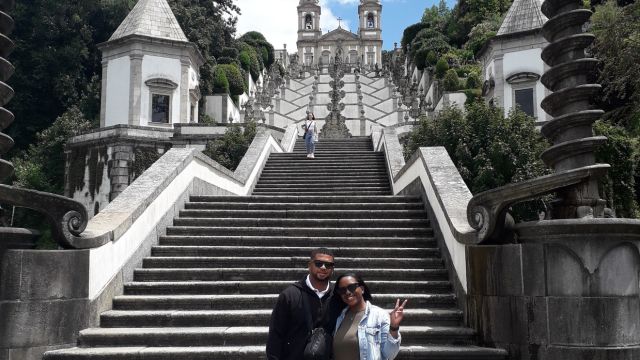 A couple stands together in front of the stunning Bom Jesus Church during their Braga sightseeing tour.