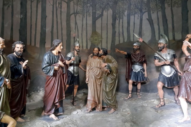 Statues of people elegantly displayed in the cave of Chapel Braga Bom Jesus, highlighting the beauty of the sacred space.