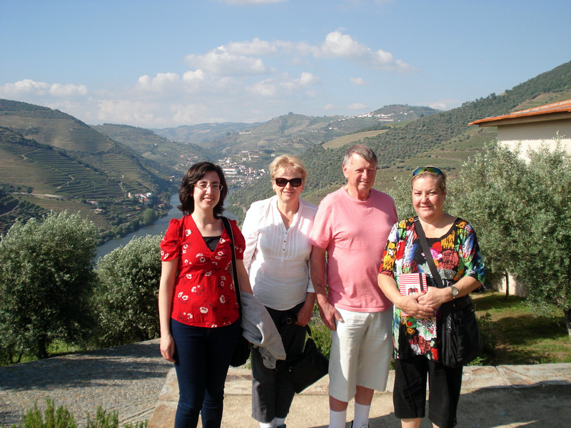 A small group of travelers enjoying a scenic stone path in the beautiful Douro Valley, surrounded by lush landscapes.