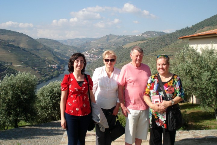 A small group of travelers enjoying a scenic stone path in the beautiful Douro Valley, surrounded by lush landscapes.