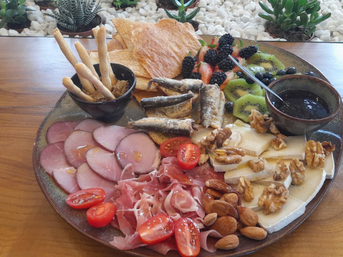 A beautifully arranged plate of gourmet food on a table, showcasing dishes from the Olive Oil Porto food tour.
