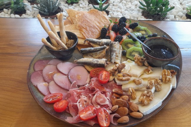 A beautifully arranged plate of gourmet food on a table, showcasing dishes from the Olive Oil Porto food tour.
