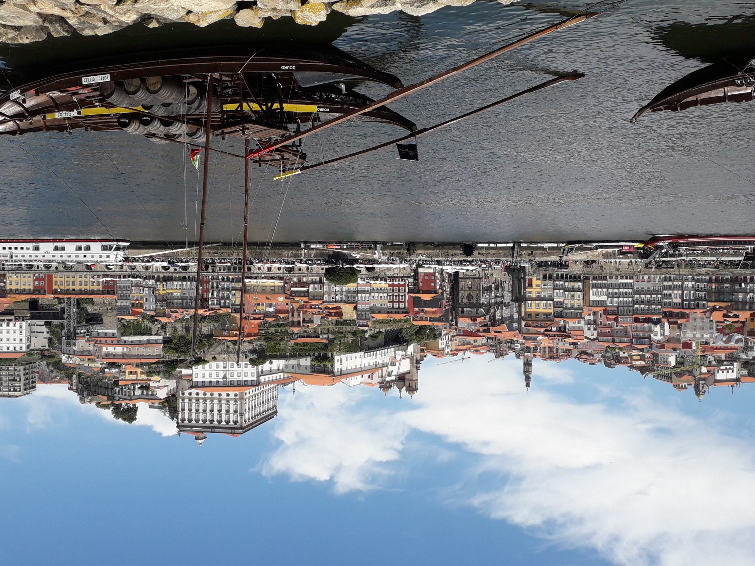 Tranquil waters in Porto, perfectly still, mirroring the surrounding beauty and inviting a sense of calm.