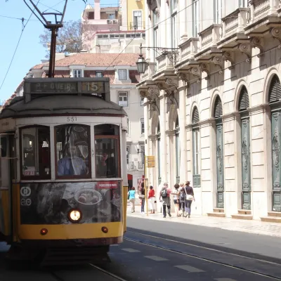 a tram is parked on the side of a building