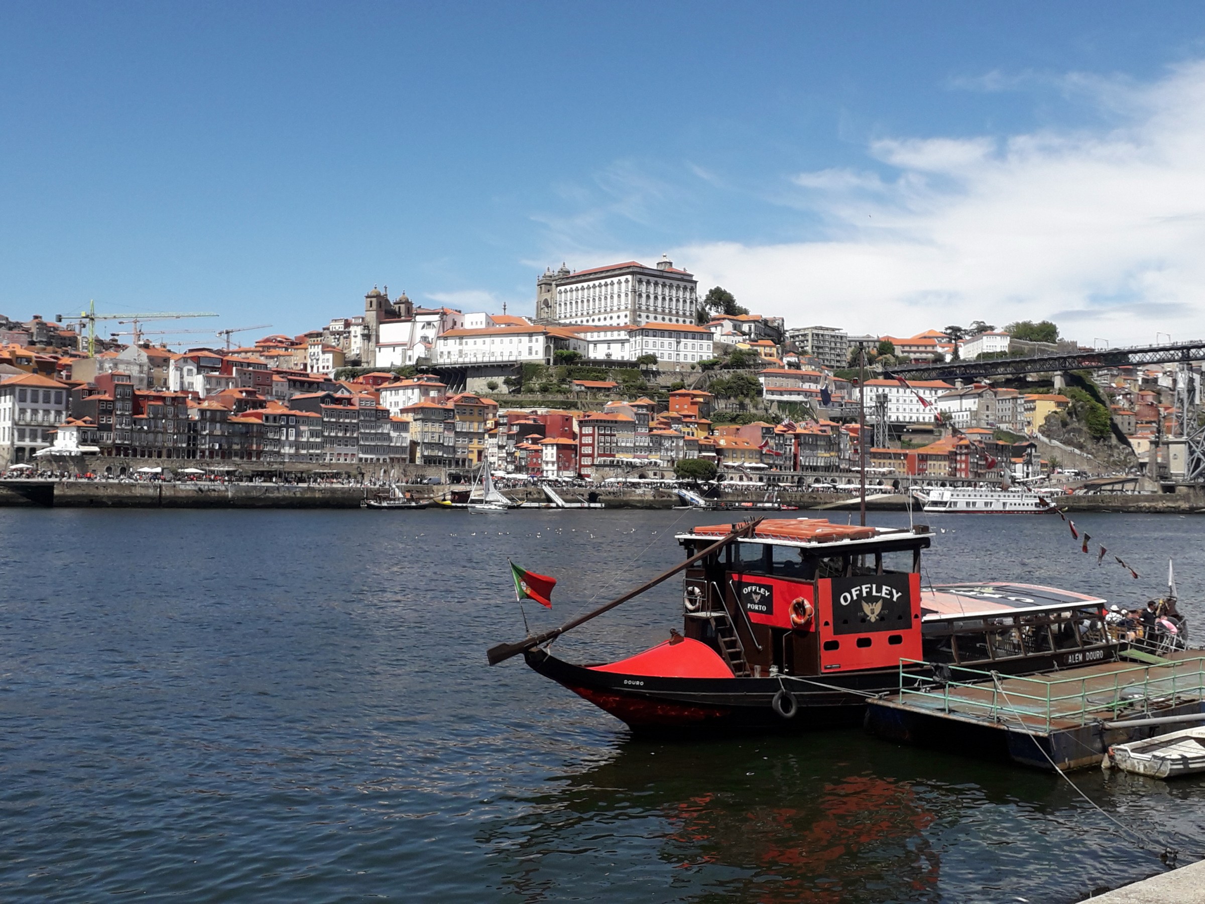 A serene view of calm waters in Porto, reflecting the soft hues of the sky, creating a peaceful atmosphere.