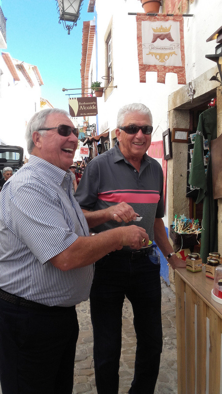 a person holding a ginjinha chocolate cups