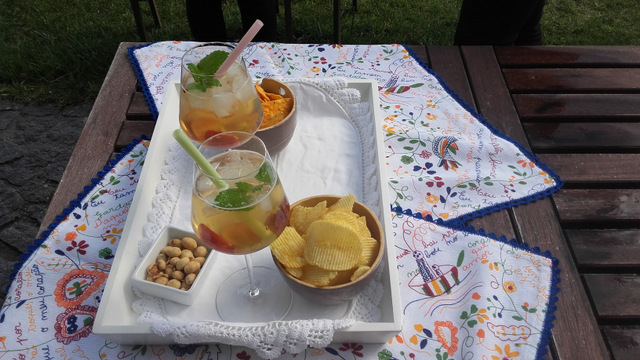 a tray of food on a picnic table and white sangria
