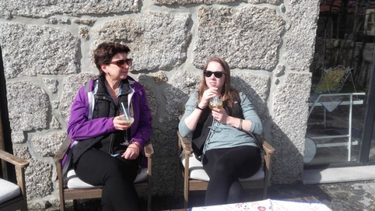 a woman sitting and enjoying a Portuguese sangria