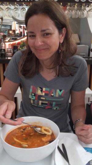 a woman eating Portuguese Seafood Rice