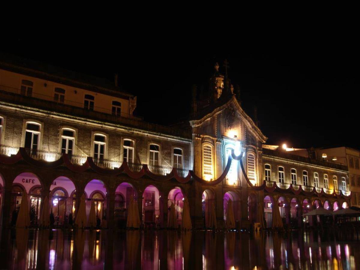 A stunningly illuminated building reflecting the lively Easter traditions in Braga, creating a magical nighttime scene.