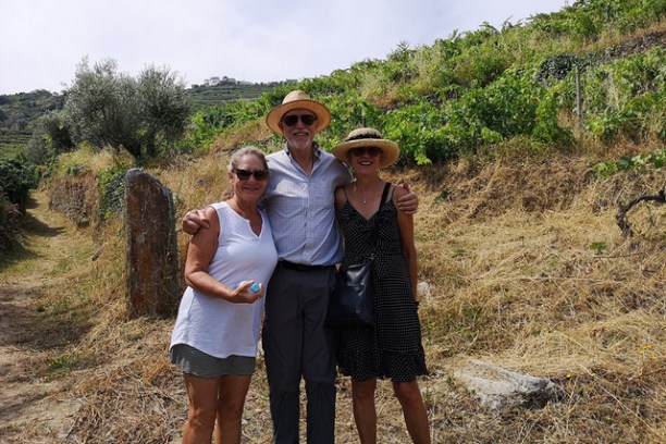 A man and two women stand on a dirt road, enjoying their Guided Walking Holidays in beautiful Portugal.