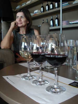 a person sitting at a table with wine glasses best porto walking tour