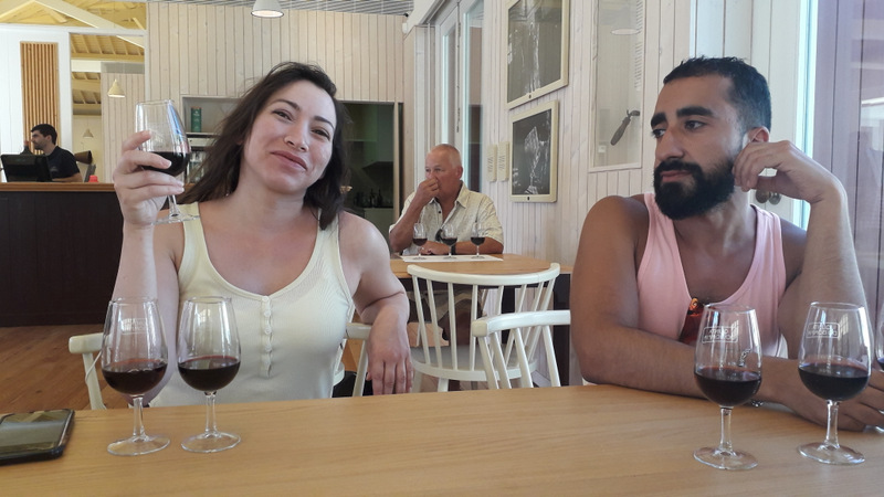 A man and woman enjoy a Douro wine tasting experience together at a cozy table, savoring fine wines and conversation.