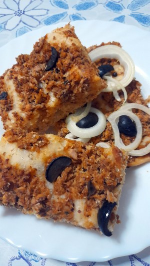 a piece of Mediterranean Sardine Pizza