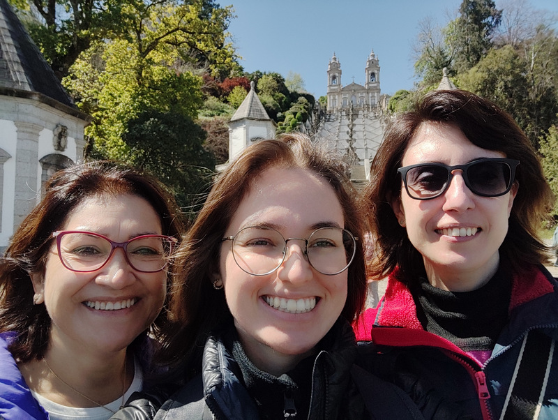 Three smiling women pose for a photo in front of Bom Jesus during their Braga half-day tour.