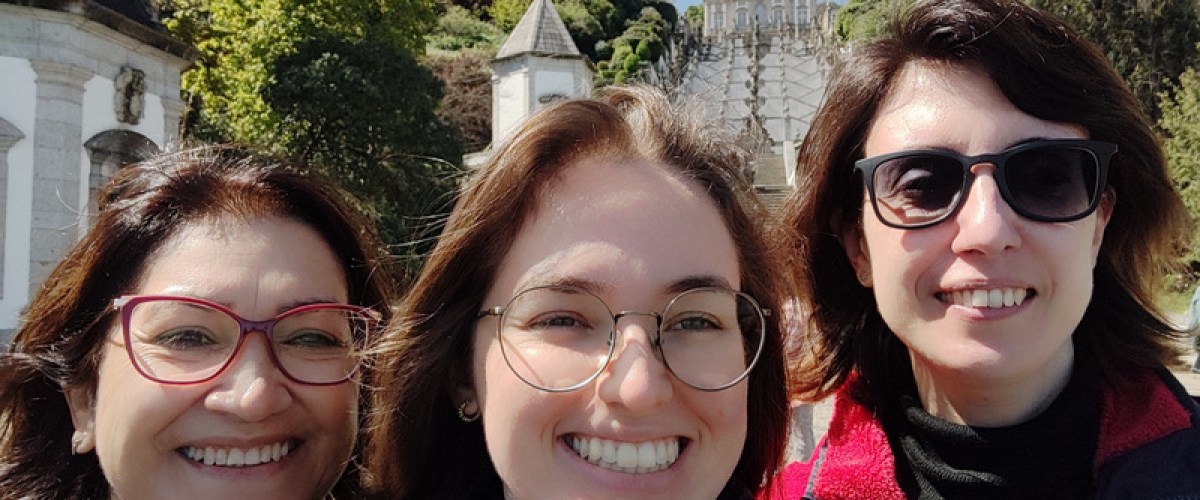 Three smiling women pose for a photo in front of Bom Jesus during their Braga half-day tour.