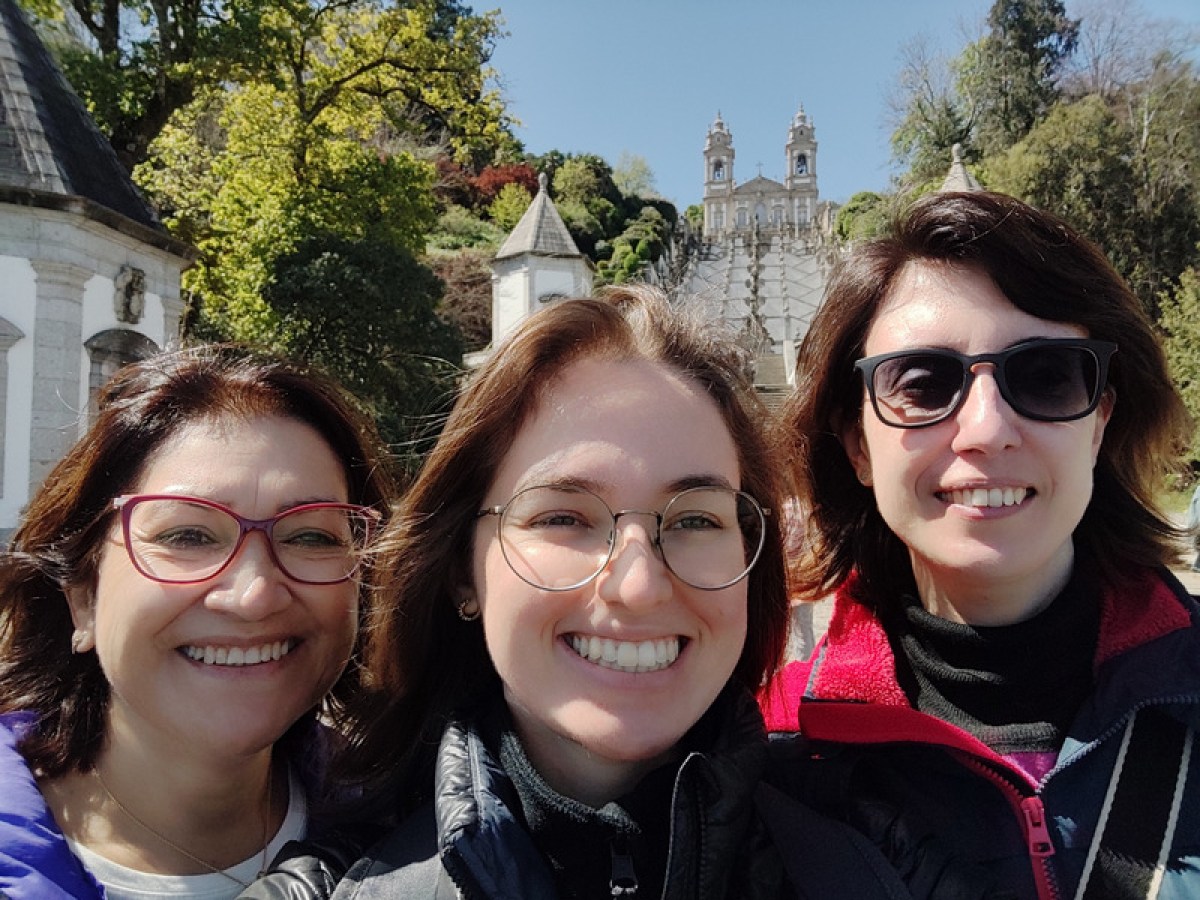 Three smiling women pose for a photo in front of Bom Jesus during their Braga half-day tour.