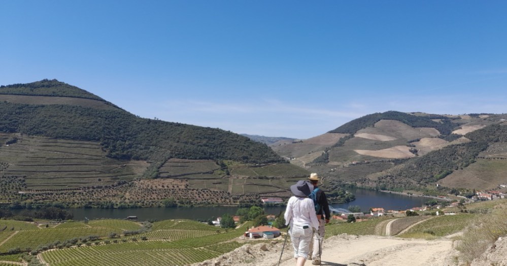 a couple enjoying the breathtaking views of the Douro Valley on a hike.