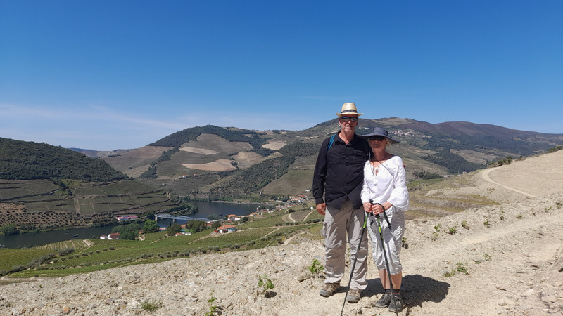 a couple hiking in the Douro vinery