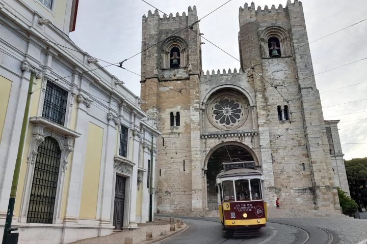 cathedral and yellow tram in lisbon