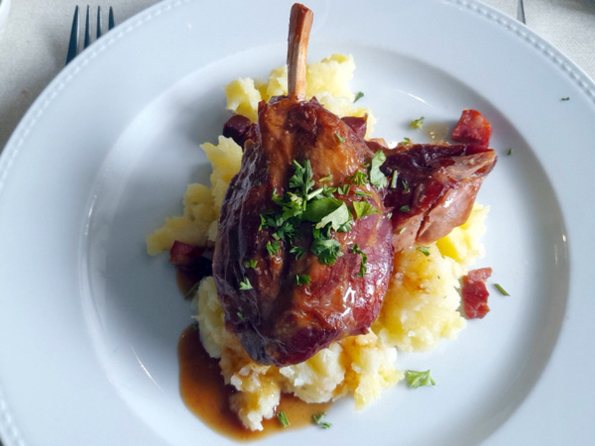 a plate of pork with potatoes during portugal food tour
