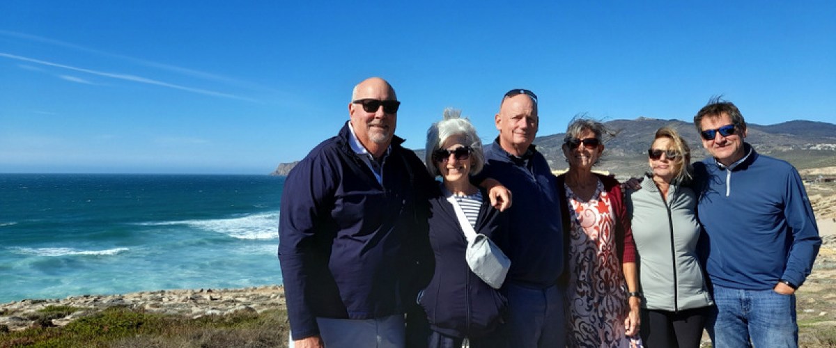 a group of people on a beach during portugal tours