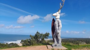 a statue in nazare beach praia norte big wave