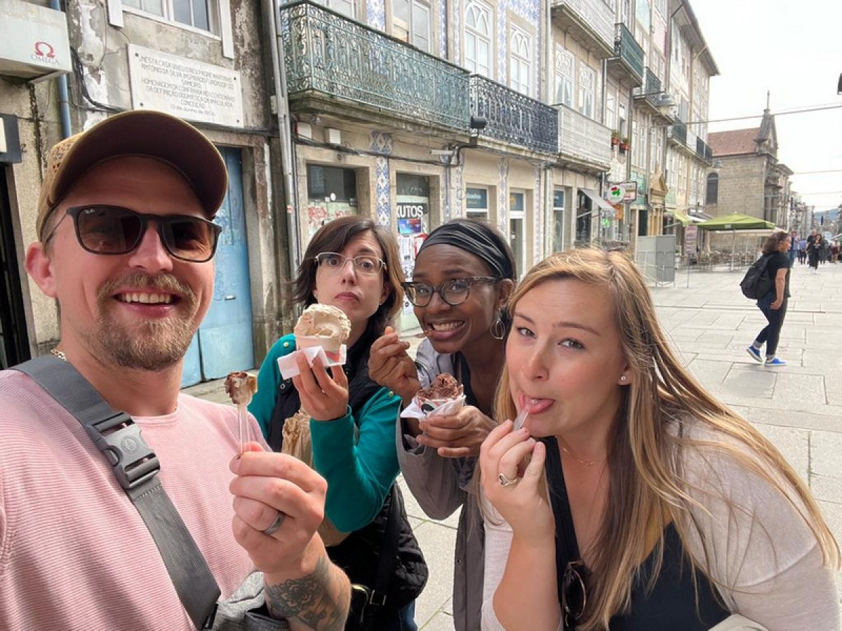 group happily take a selfie with their ice cream during a food tour in Braga, Portugal, sharing a fun experience.