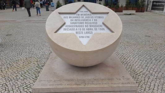 a sign in front of a statue jewish tours portugal