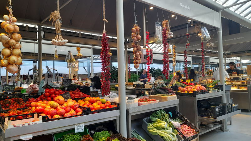 a variety of fruits and vegetables on display in Porto Bolhao farm market