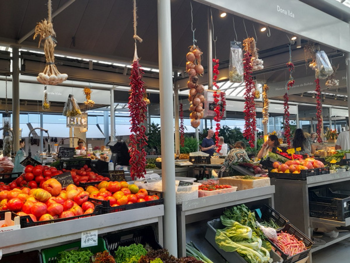 a variety of fruits and vegetables on display in Porto Bolhao farm market
