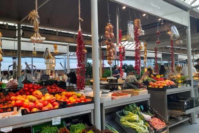 a variety of fruits and vegetables on display in Porto Bolhao farm market