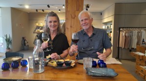 a person holding a bottle of wine on a table