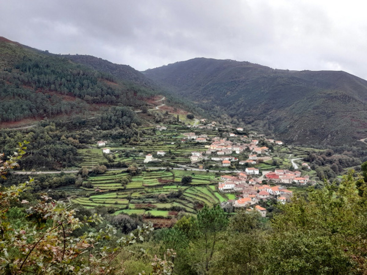 A picturesque mountain village in Sistelo, Portugal, surrounded by lush greenery and rolling hills, showcasing serene countryside beauty.