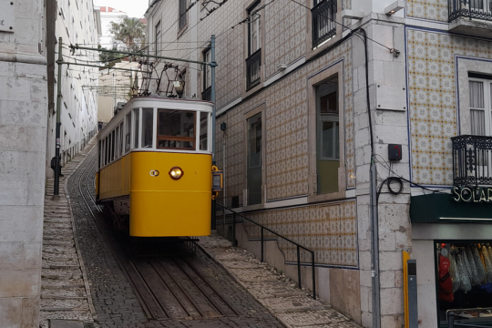 The yellow funicular in Lisbon, highlighting the excitement of exploring the city on a tour.