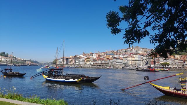 A serene boat floats on the Douro River, capturing the essence of Porto's cooking classes in a picturesque setting.