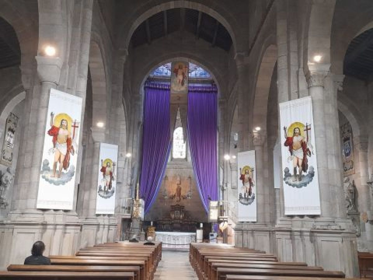 Inside a Braga cathedral adorned with purple banners, capturing the essence of Easter celebrations in Portugal.